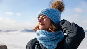 Portret van vrouw in winterse omgeving met de winterzon op haar gezicht.