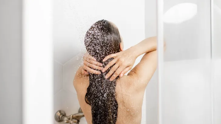 Woman washing hair in the shower