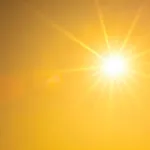 Hot summer or heat wave background, orange sky with glowing sun