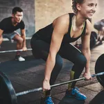 Woman performing dead lift barbell exercise