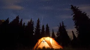 stars above the mountains with tent highlighted