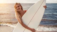 Young woman with surfboard