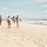 Shot of an adorable little girl having a fun day at the beach with her parents and grandparents