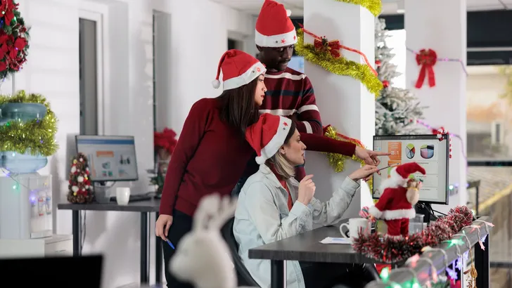 Employees analyzing figures on Christmas
