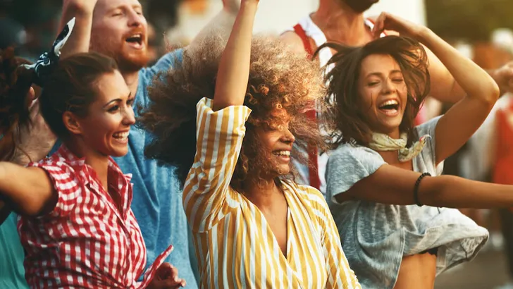 Group of friends dancing at a concert.