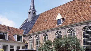 Old almshouses around a small, public courtyard