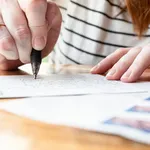 Woman Writing on a Postcard