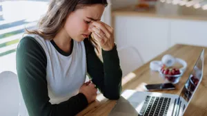 Portrait of tired woman with laptop, homeoffice concept.