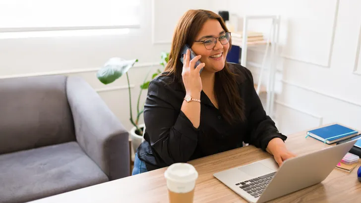 Cheerful businesswoman having a business call