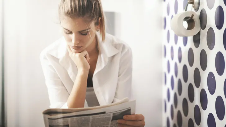 Reading newspapers in toilet.