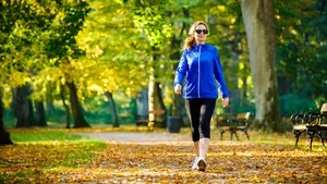 Mid aged woman running in city park