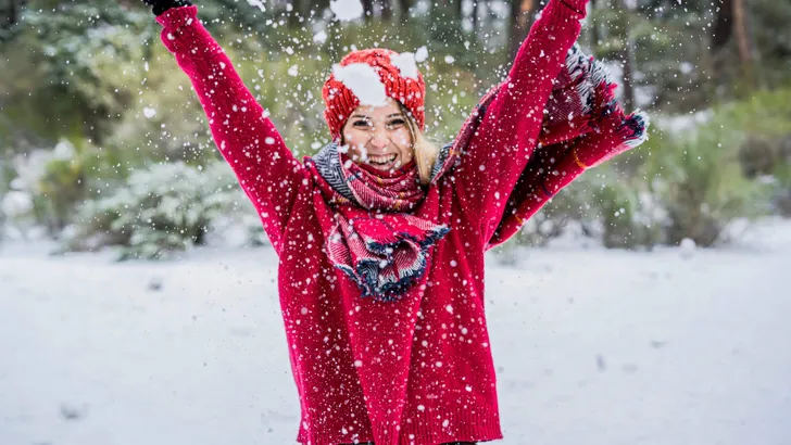 Winter young woman portrait. Beauty Joyful Model Girl laughing and having fun in winter park.