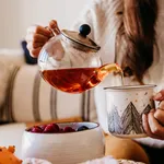 woman having a cup of tea at home during breakfast. Cute golden