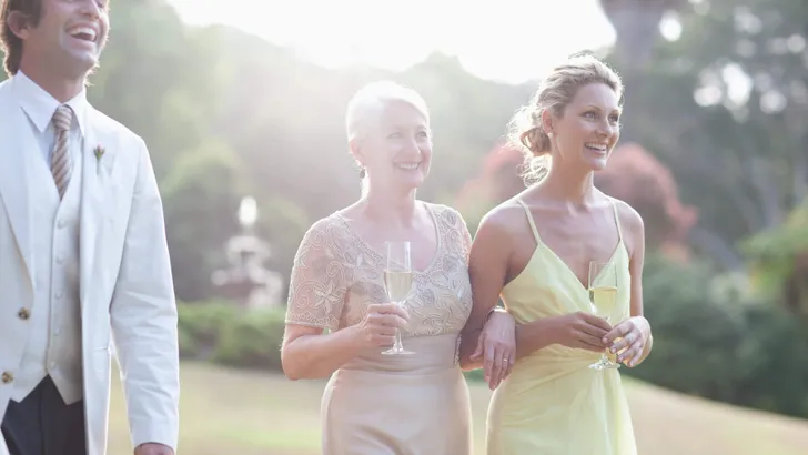 Wedding guests walking across lawn