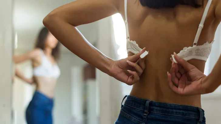 Young woman closing her bra