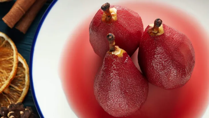 Tasty and delicious food concept - pear in wine