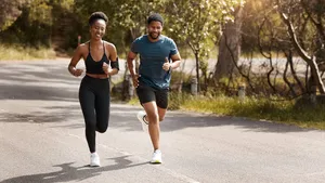 Health, exercise and black couple running, nature and workout goal with endurance, training and wellness. Runners, man and woman in the street, run and progress with health, performance and fitness