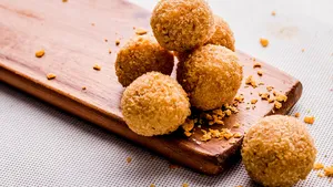 Mac and Cheese balls isolated on wooden board side view on grey background fastfood