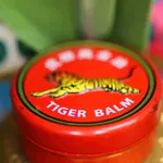 Viersen, Germany - May 9. 2022: Closeup of jar lid cover with asian analgetic heat tiger balm rub ointment