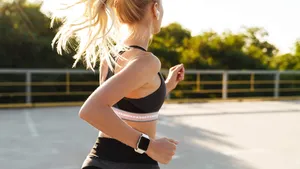 Image of attractive fitness woman wearing tracksuit running outd