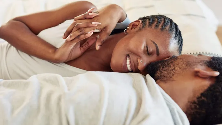 Shot of a young couple being intimate in bed at home