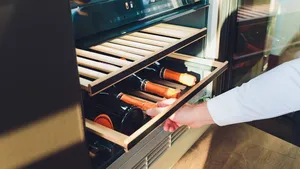 Storing bottles of wine in fridge. Alcoholic card in restaurant. Cooling and preserving wine.