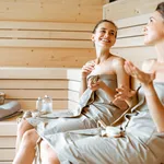 Two girlfriends relaxing in the sauna