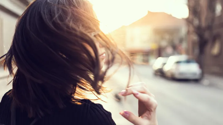 Dynamic Portrait of Girl with Sun Flare on the street.