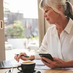 Senior businesswoman busy working at a cafe