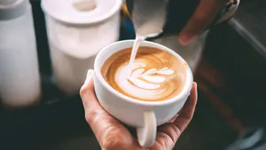 Barista made coffee latte in a coffee shop.