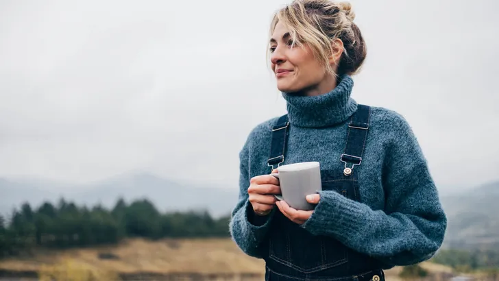 Beautiful Woman Drinking Tea in Nature