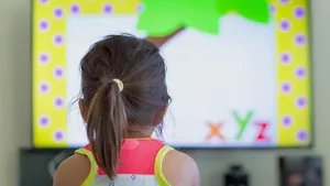 Children watching tv at home. Preschool education.