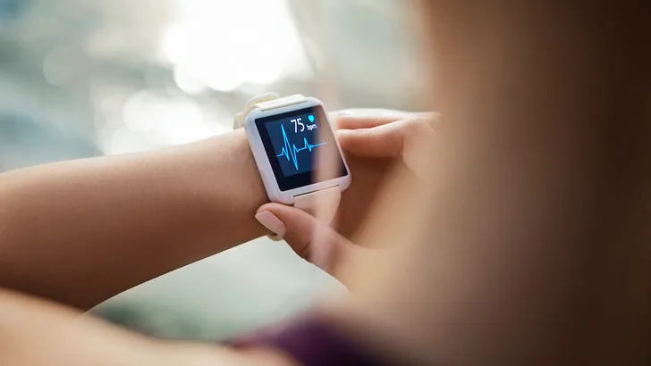 Woman Looking At Her Smart Watch for a pulse trace