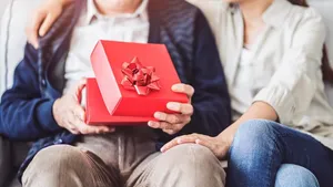 Young daughter gives her father a gift