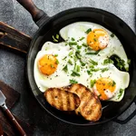 fried eggs in a cast iron pan top view