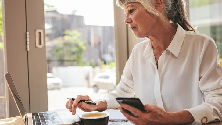 Senior businesswoman busy working at a cafe