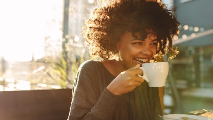 Woman drinking coffee at a coffee shop