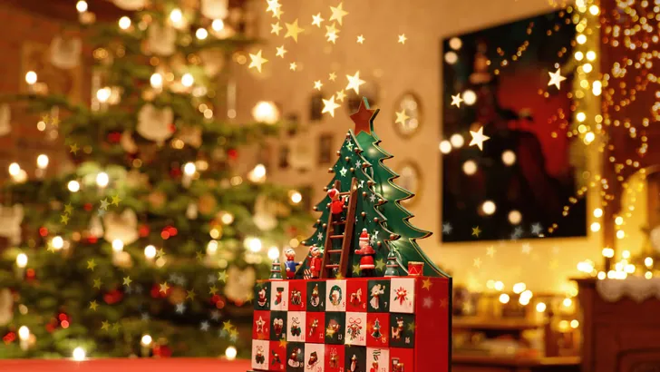 Three-dimensional Advent Calendar with stylised Christmas Tree in the middle of Christmassy illuminated Family Room