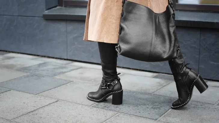 Stylish woman in black shoes walking down the street