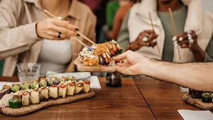 Friends enjoying sharing Vegan Sushi in a local restaurant