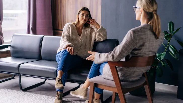A young woman in a consultation with a psychologist listens to advice on improving behavior in life.