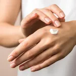 skincare. close up view of woman hand moisturising them with cream. skincare