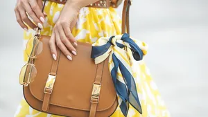 Women`s accessories. Female holding her purse close up.