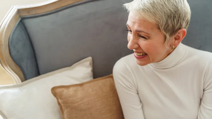 Cheerful Caucasian short-haired elderly lady looking away