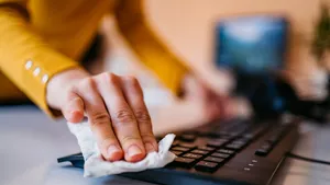 Woman cleaning keyboard