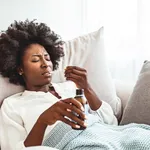 Girl drinks a medicine.