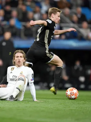Frenkie de Jong snelt voorbij Modric en Vinícius Júnior tijdens Real-Ajax