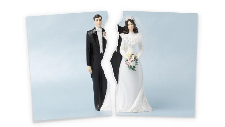 Divorce.Torn photograf of wedding cake topper