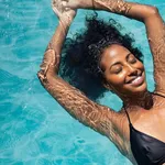 Happy woman relaxing in swimming pool