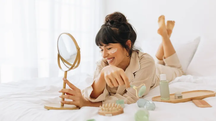 Woman enjoying skin care activity at home